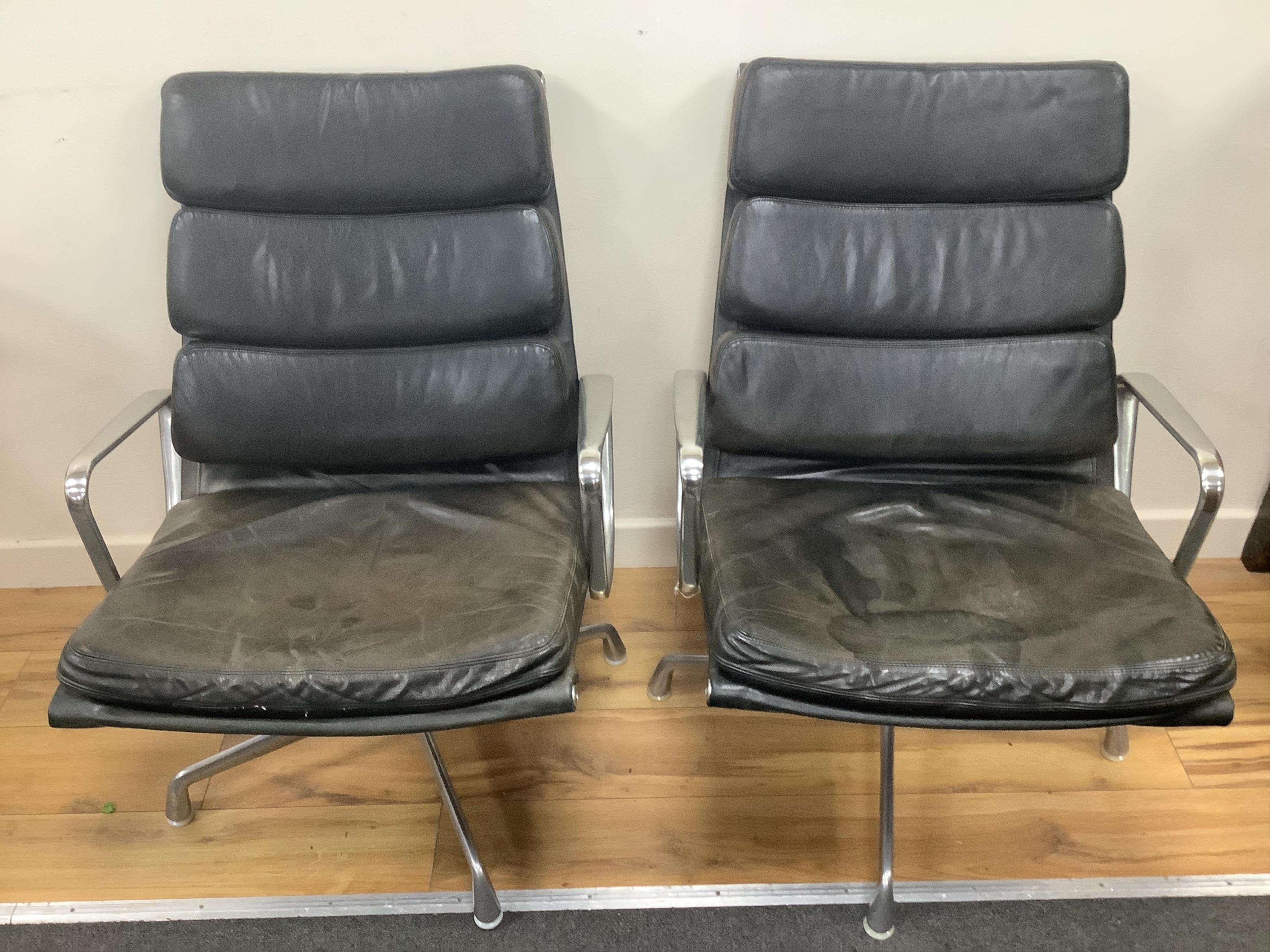 Charles and Ray Eames for Herman Miller, a pair of EA216 black leather and aluminium high back swivel armchairs, width 62cm, depth 69cm, height 87cm. Condition - fair